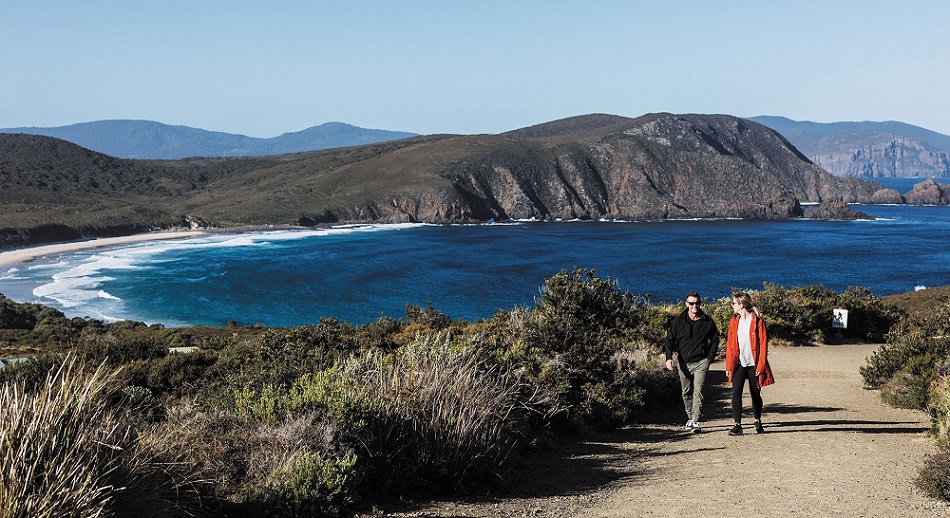 Couple walking at Lighthouse Bay