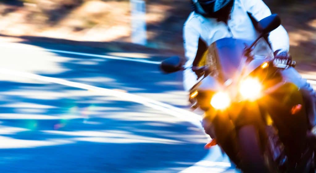 A motorcyclist riding on the road.