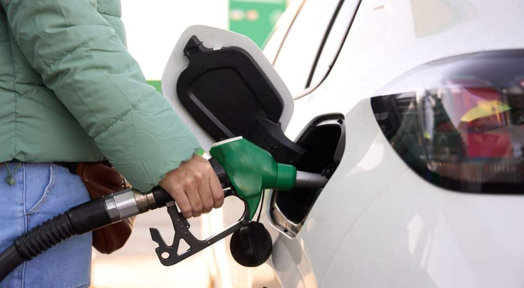 A person filling their car with petrol at the service station.