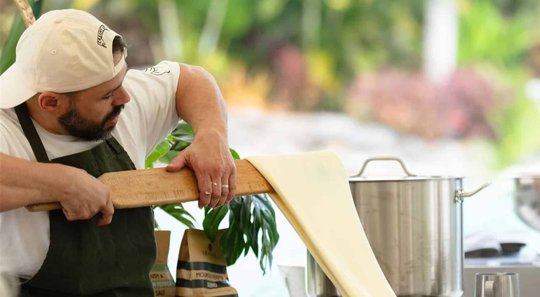 A person  stretching cheese during a demonstration.