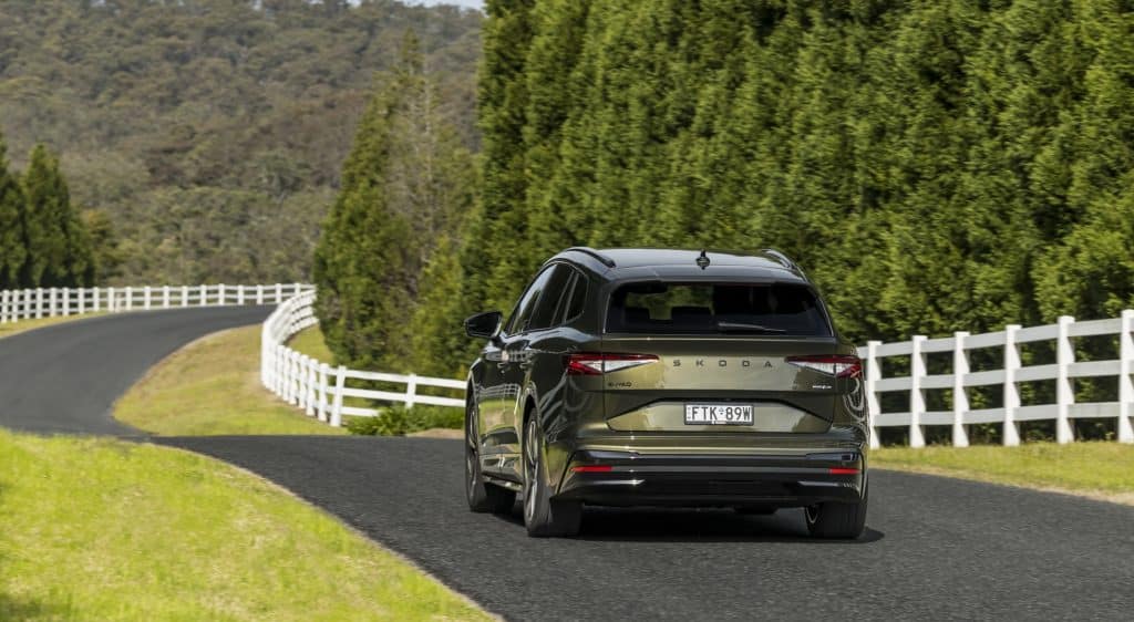 Green car driving away in the country