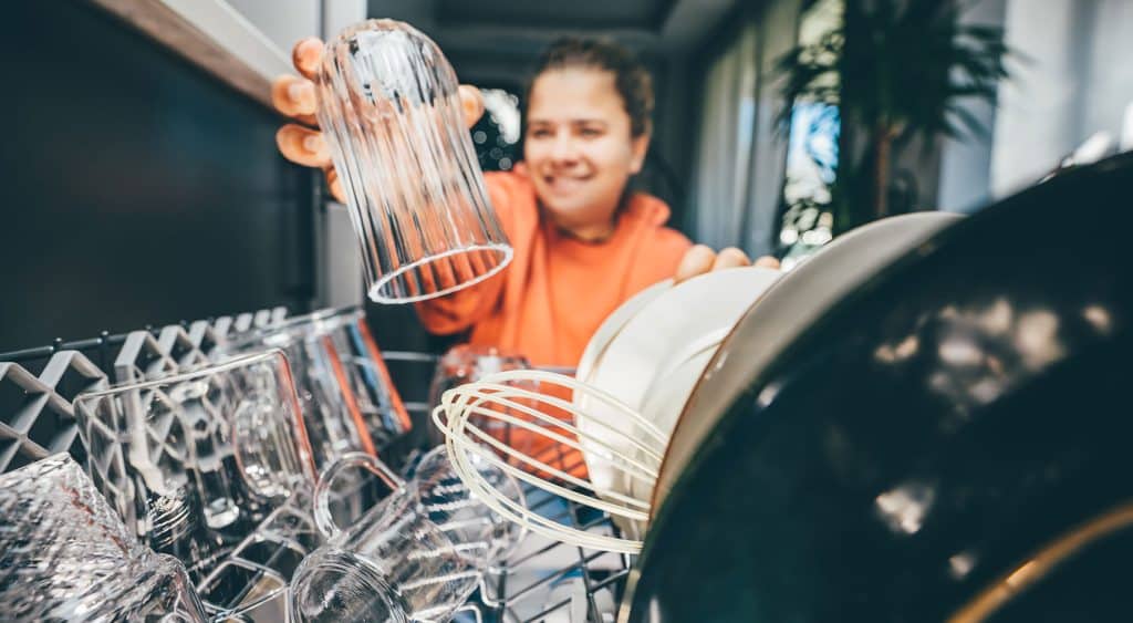 A woman stacking her diswasher