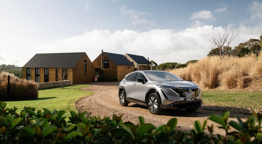 Car on the driveway of a country house