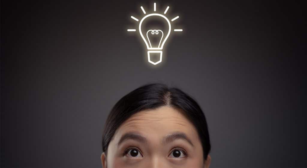 Woman with a holographic image of a light bulb above her head