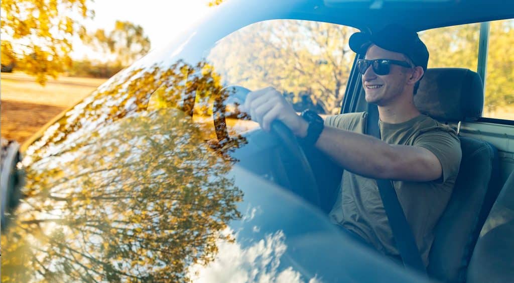 Driving a car, wearing sunglasses