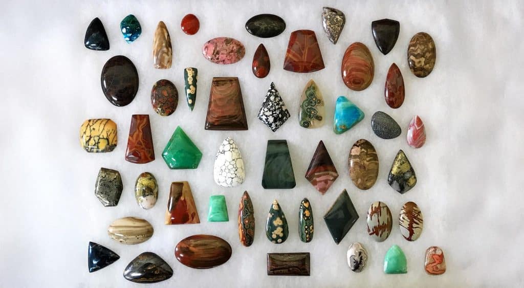 Different gem stones laid out in rows.