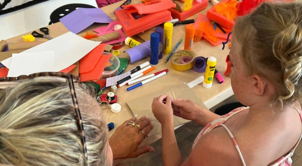 Older woman and young child with craft supplies.