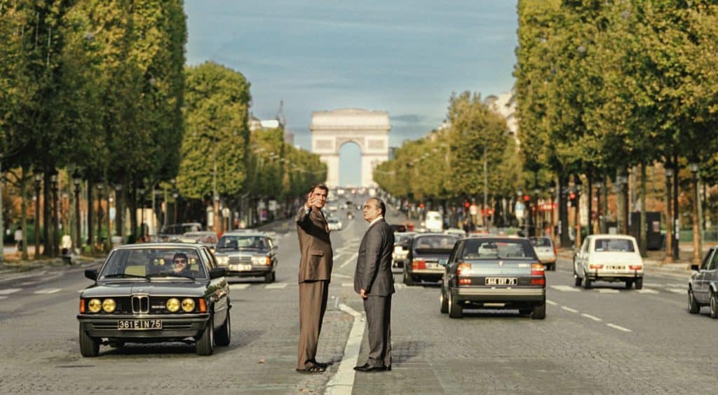 Still from The Great Arch with two men standing in the middle of a street.
