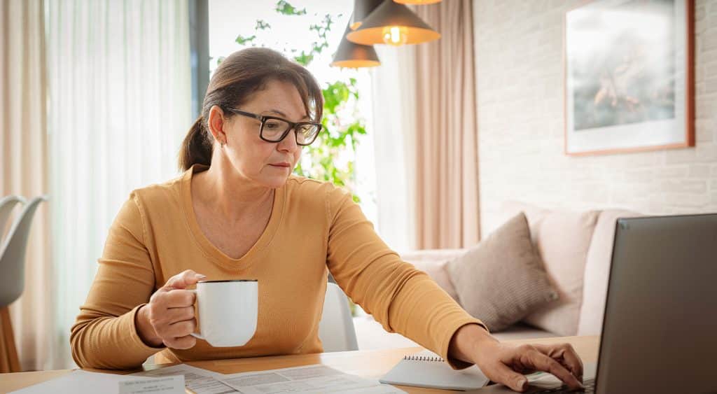 A lady checking her energy bill on the computer.