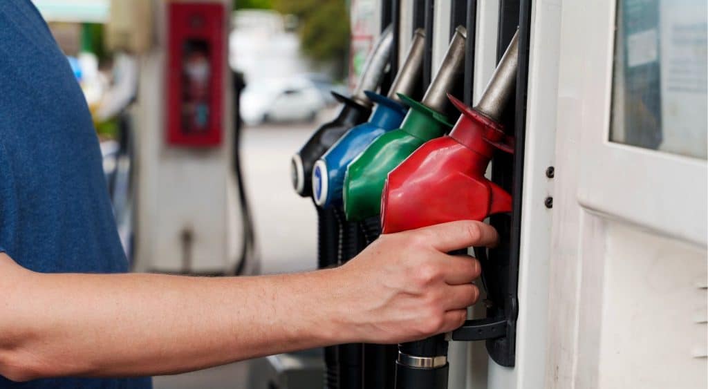 Person holding fuel nozzle.