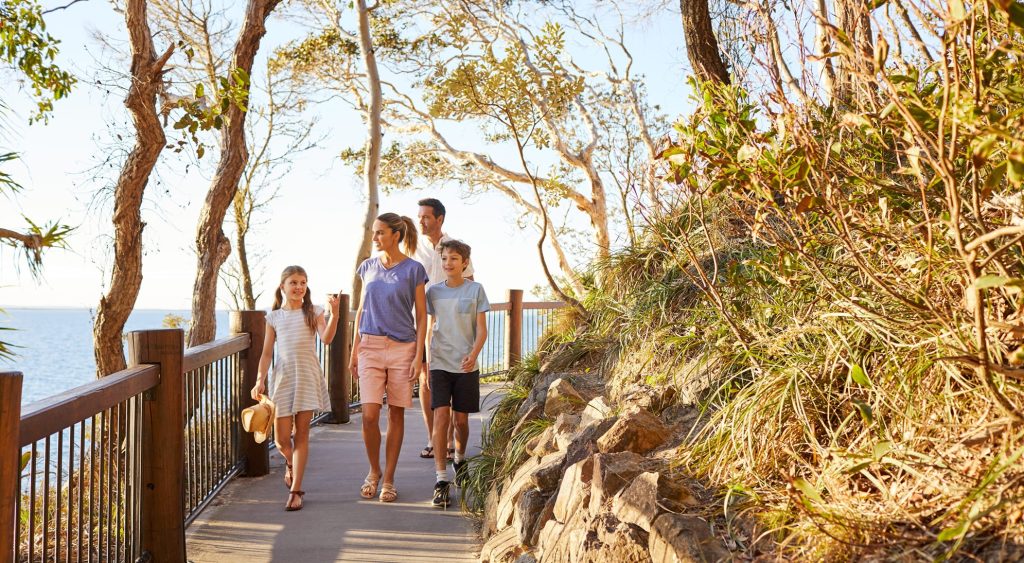 Family walking along a boardwalk