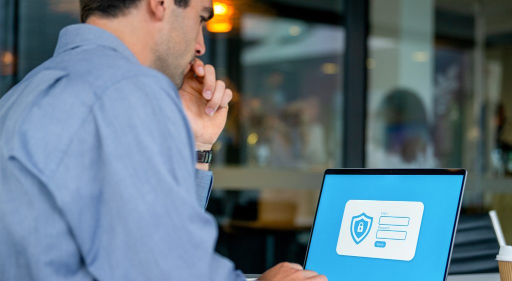 A man looks at a web login page on his laptop