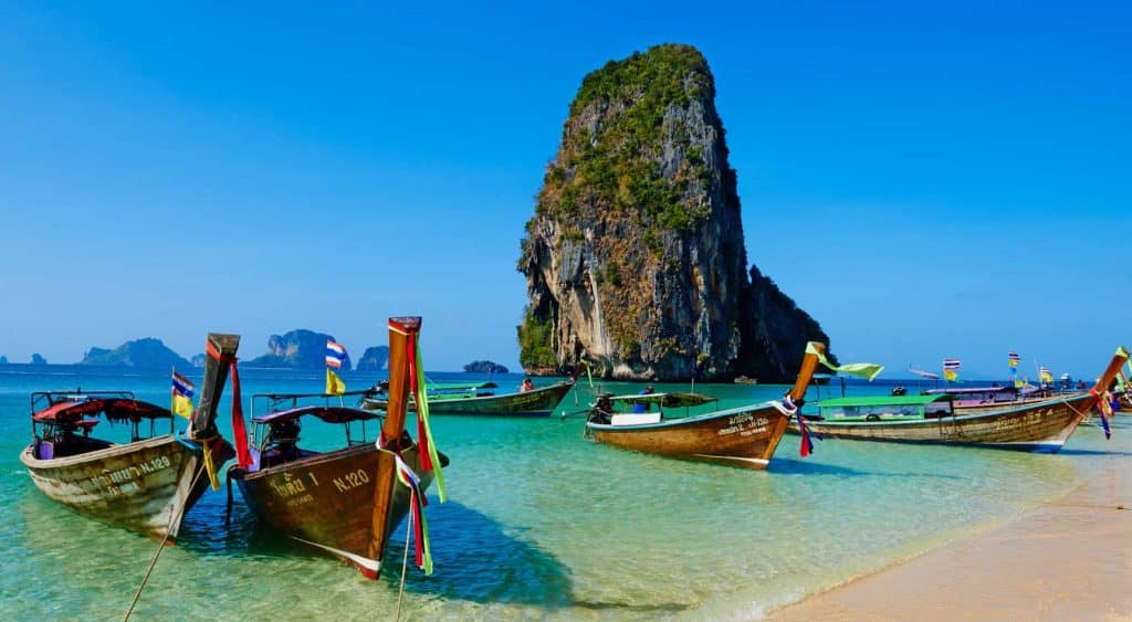 A Thai beach with boats nestled on the shore.