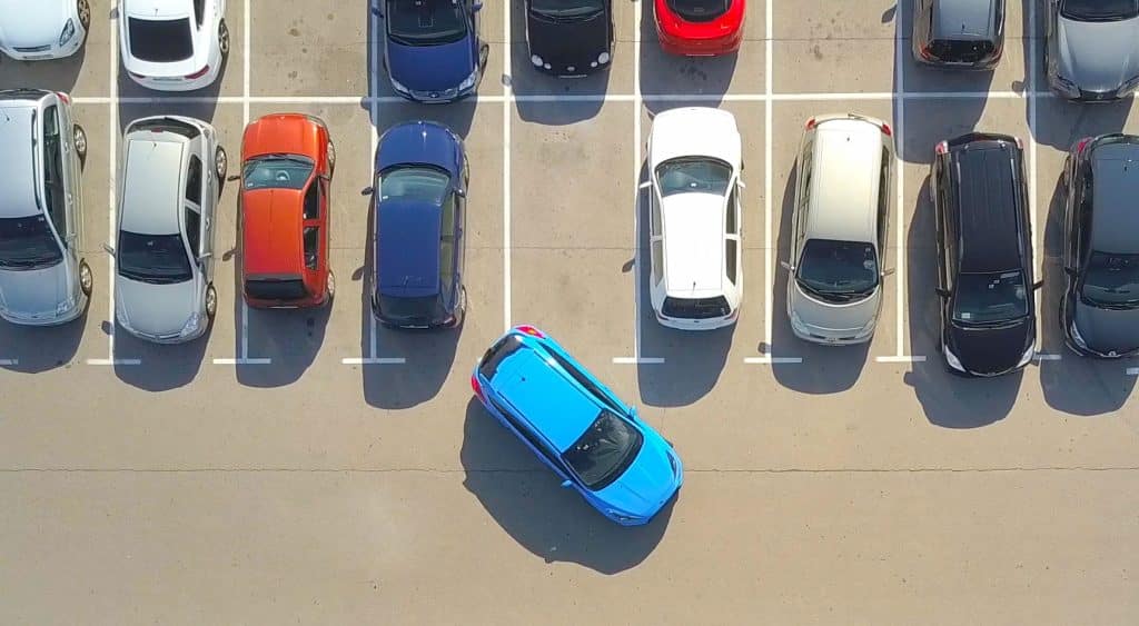 Car struggling to reverse into a car park space