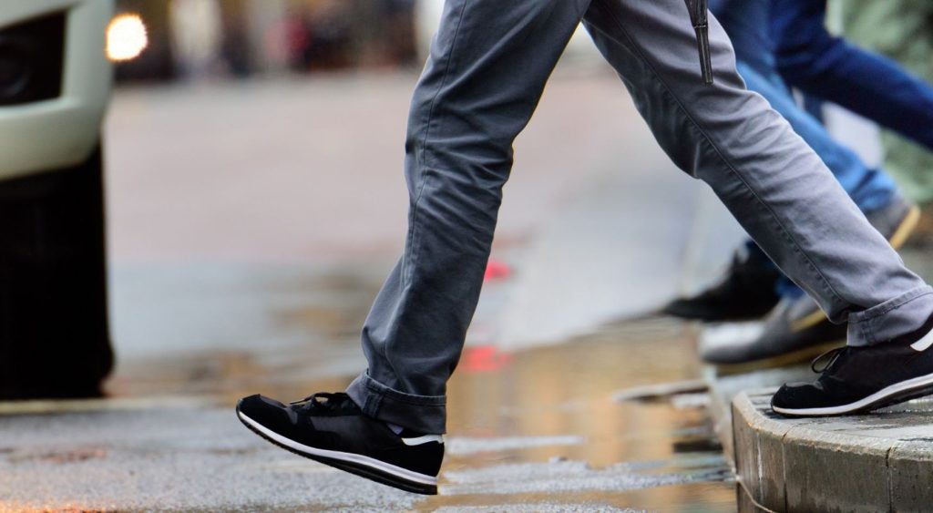 Pedestrians stepping out onto the road.